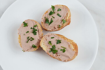 Duck or goose liver pate sandwiches on a plate