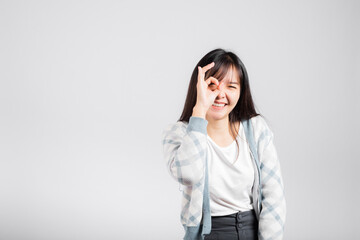 Woman smiling showing made finger OK symbol sign to agree studio shot isolated white background, Happy Asian portrait beautiful young female lifestyle agree hand sign with copy space