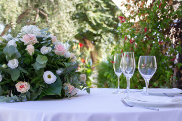 able set for two and decorated with flower bouquet for event