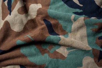 Military camouflage cloth pattern texture, alternating colors on a beautiful cloth background image.