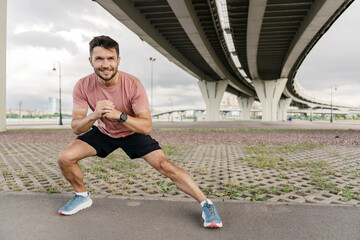 Warm-up runner interval training. Confident person exercise fitness for health.  A man is taking a break from rest, jogging in sports clothes. Uses running shoes.