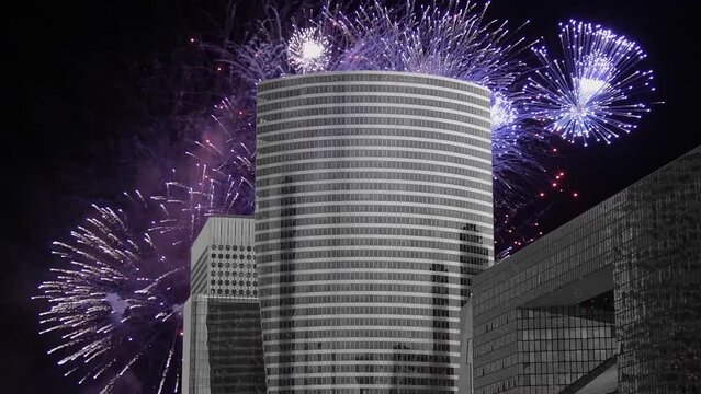 Celebratory fireworks over the Skyscrapers La Defense (4K, time lapse, with zoom), commercial and business center of Paris, France