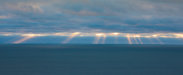 Beams of sunlight sneaking through the clouds © Guy Sagi