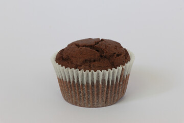 Chocolate muffins on white background. Homemade fluffy and moist chocolate cakes. Isolated