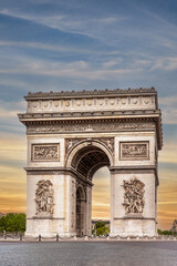 Fototapeta na wymiar Paris, France: Arc de Triomphe in De Gaulle Square at the end of the Champs Elysées. Sky with sunset colors