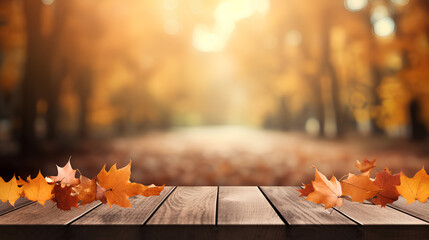 Naklejka na ściany i meble Beautiful colorful natural autumn background for presentation. Fallen dry orange leaves on wooden boards against the backdrop of a blurry autumn park