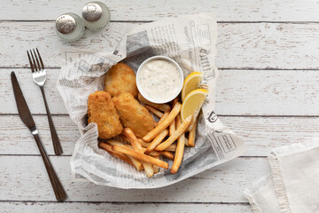 Homemade fish and chips fresh out of the oven with tartar sauce.