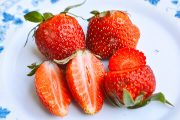 Close-up View Fresh Organic Red Whole And Sliced Strawberries On A Plate 