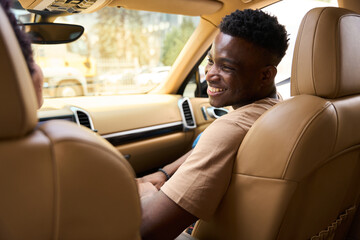 Married African American couple communicates cheerfully in a comfortable car