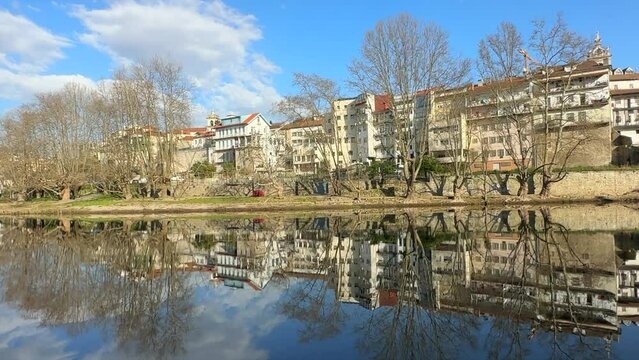 Reflection of cityscape in the Tamega River, Amarante, Portugal