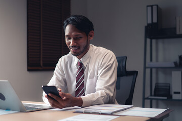 Businessman using smartphone to checking report while analysis financial and accounting of project