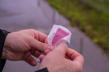 Chewing gum or sweets in mans hands. 