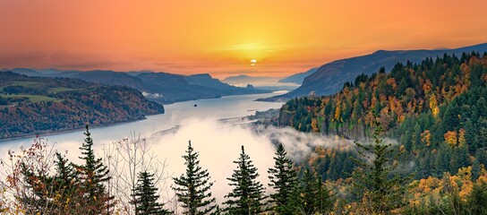 Crown Point, the vista house and the columbia River Gorge with fog, trees showing autumn colors, Oregon