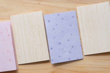 folded scrapbooking paper cards arranged on a wooden surface