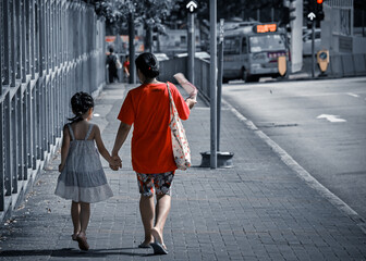 Filipino domestic helper girls escorting their employers' children on their way home from school in Hong Kong