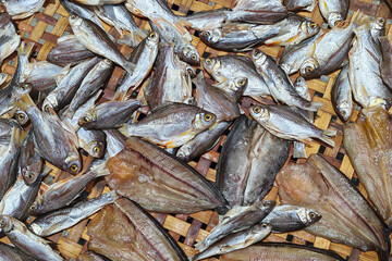 dried sea fish on bamboo basket dry by sunlight. Preserved food