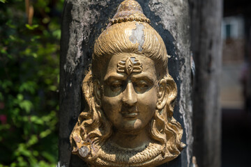 Hindu God Shiva Durga statue attached on cement pillar