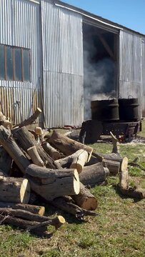 Rural image Preparations for the manufacture of food in a field. Boiling rustic cauldron and logs. Vertical FHD footage