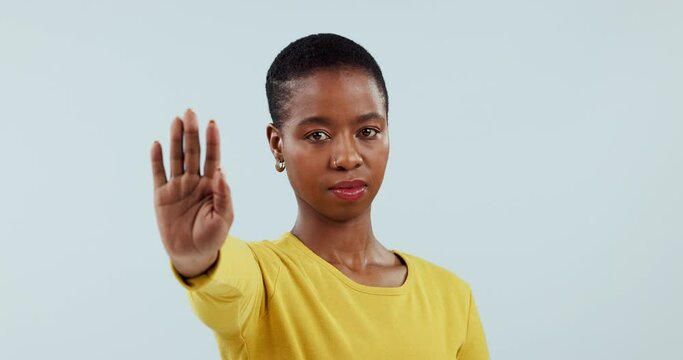 Woman, face and stop with hands, warning and caution of rejection sign in studio on white background. Portrait, african model and protest with palm for no emoji, ban or vote to fight for human rights