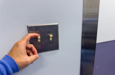 light switch in a dimly lit room, showcasing anticipation, connection, and the power of choice