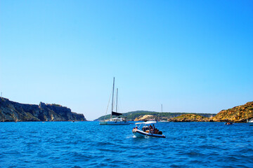 Energizing view from Tremiti Islands (Isole Tremiti) at a couple of boats, near and far, skimming...