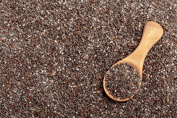 Chia seeds close-up with a wooden spoon. Chia seeds macro. Dry healthy supplement for proper nutrition.