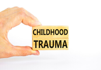 Childhood trauma symbol. Concept words Childhood trauma on beautiful wooden blocks. Beautiful white background. Psychologist hand. Business psychology childhood trauma concept. Copy space.