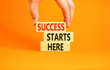 Success starts here symbol. Concept word Success starts here on beautiful wooden block. Businessman...