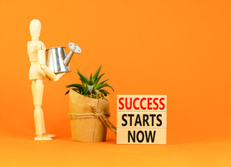 Success starts now symbol. Concept word Success starts now on beautiful wooden block. Businessman...