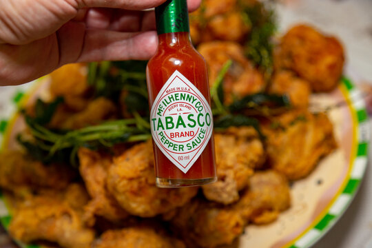 Brasilia, DF, Brazil, September 16, 2023: Traditional fried chicken with aromatic herbs, thyme and sage. Tabasco pepper sauce