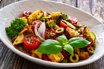 Italian style food - panzanella salad on wooden table
