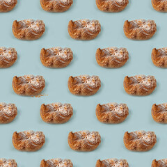 puff pastry buns of fancy shape, with crumbs, on a blue background, pattern