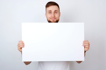 Fototapeta premium Man holds the blank card. Placard for your text