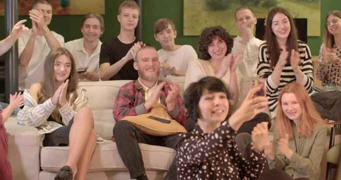 Positive motivation. Greeting closing Clapping is used as a greeting beginning lesson at the end some important part lesson teacher takes selfie phone with group students.