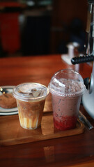 Closeup of Iced Caramel Macchiato at the coffee shop, Caramel Macchiato is a classic macchiato beverage. It consists of vanilla syrup, espresso, steamed milk, foam, and caramel drizzle