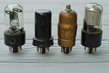 four  different whole glass and iron  retro electric historical vacuum radio tubes with metal...