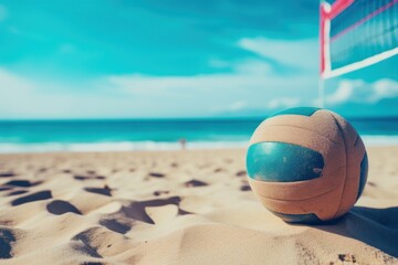 A volleyball ball is pictured on a beach with a volleyball net in the background. This image can be used to represent beach sports and recreational activities. - obrazy, fototapety, plakaty