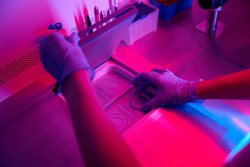 Laboratory assistant opens the lid into a special apparatus