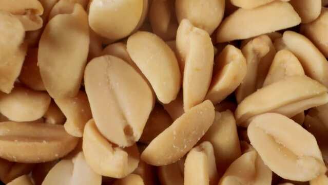 Salted peanuts snack food. Peanuts seeds Close-up. Salty snack. Salted roasted peanuts.