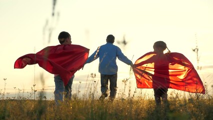 little children father dream becoming superheroes. Son daughter play with father street sunset, red...