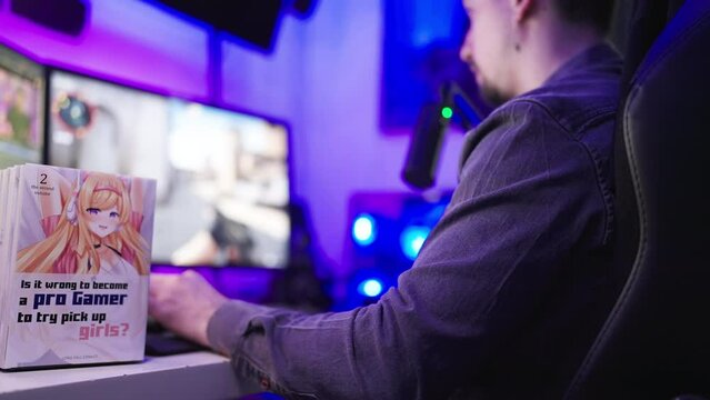 Manga comic cover with cute anime girl on table while man gaming in background 
