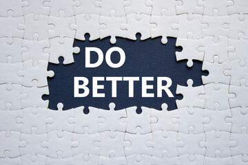 Do better symbol. White puzzle with words Do better. Beautiful dark blue background. Business and Do better concept. Copy space.