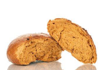 Loaf of bread broken in half with raisins, macro, isolated on white background.