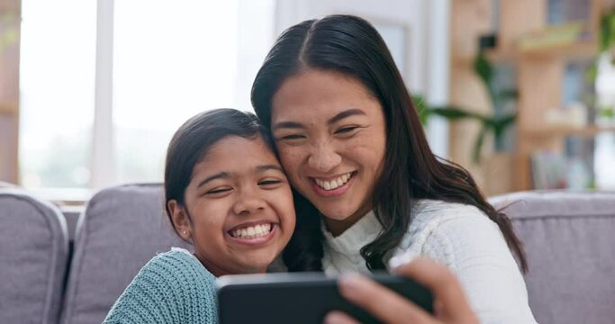 Love, kiss and selfie by mother and girl child on a sofa hug, care and happy in their home together. Smartphone, profile picture and kid with mom in a living room smile for photo, bond and memory