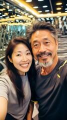Naklejka premium Selfie of a 40-year-old Asian couple in a fitness club
