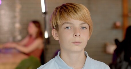 Close portrait of young guy teenager boy indoors. Student Person silent focused gaze into the...
