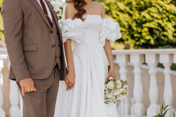 sensitive ceremony of the bride and groom. A happy newlywed couple is standing against the...