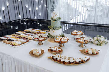 Wedding monobloc with delicious desserts. Strawberry cupcakes, jellies and modern desserts, stylish restaurant wedding decorations