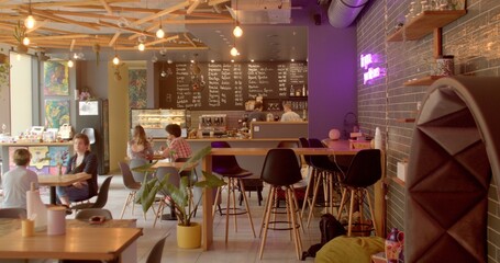 Cafe exudes a cozy ambiance with visitors. Thriving coffee business, a hub where aromatic brews and...