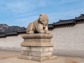 a statue of Haitai standing in front of Gwanghwamun Gate